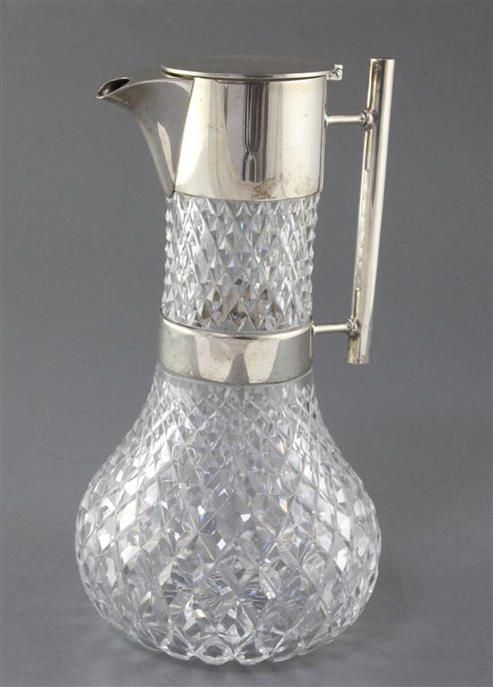 A late Victorian silver mounted cut glass claret jug by Hukin & Heath, in the manner of Christopher Dresser, 26cm.